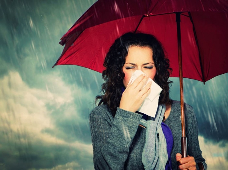 bigstock-sneezing-woman-with-umbrella-o-52297741_750x558