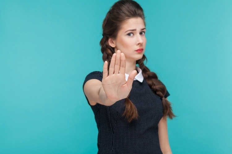 body-language-bad-emotion-serious-woman-showing-stop-sign-at-camera-picture-id925000720