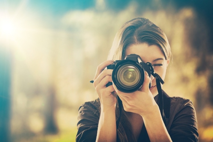 portrait-of-a-photographer-covering-her-face-with-camera-picture-id664304668_02