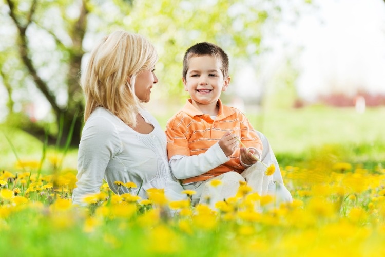mother-and-child-relaxing-on-the-flower-meadow-picture-id185105395