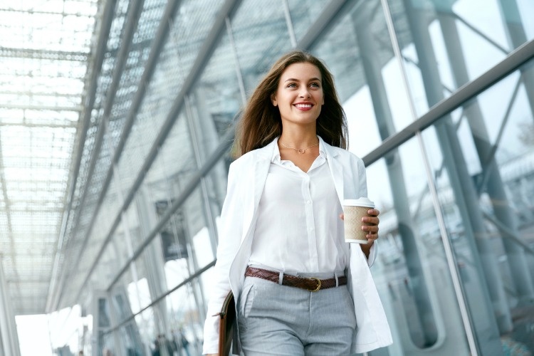 beautiful-woman-going-to-work-with-coffee-picture-id970923568