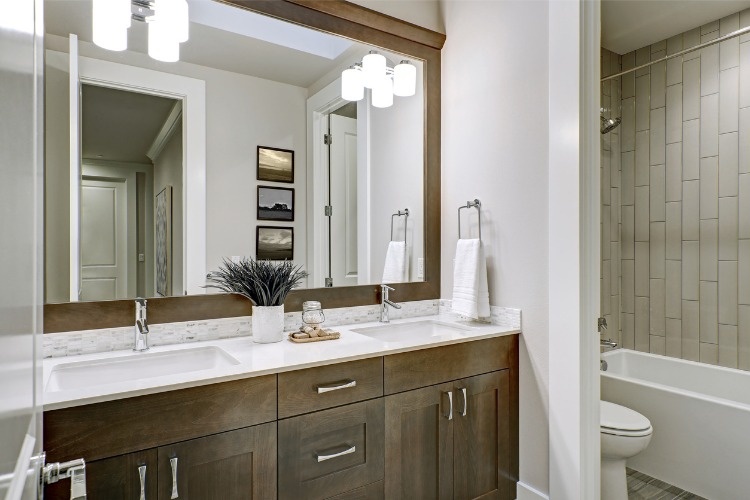 white-and-brown-bathroom-boasts-a-nook-filled-with-double-vanity-picture-id877877788