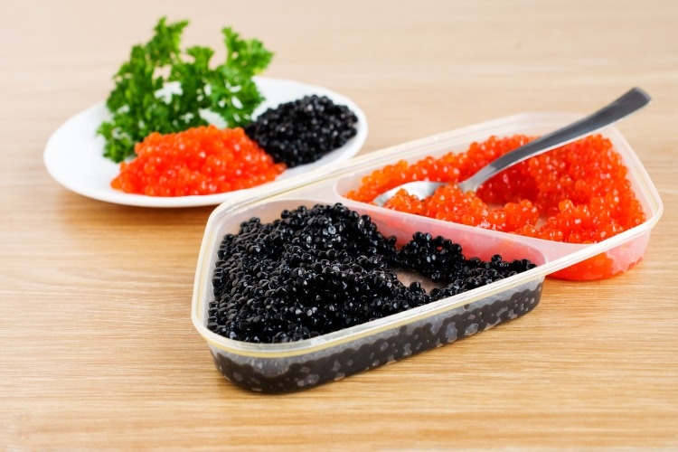 red-and-black-caviar-is-in-a-serving-plate-picture-id450479335