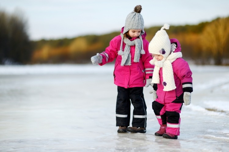 two-little-sisters-having-fun-on-snowy-winter-day-picture-id881260702